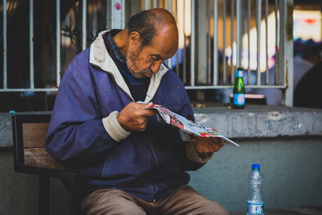 elderly man reading utility bill