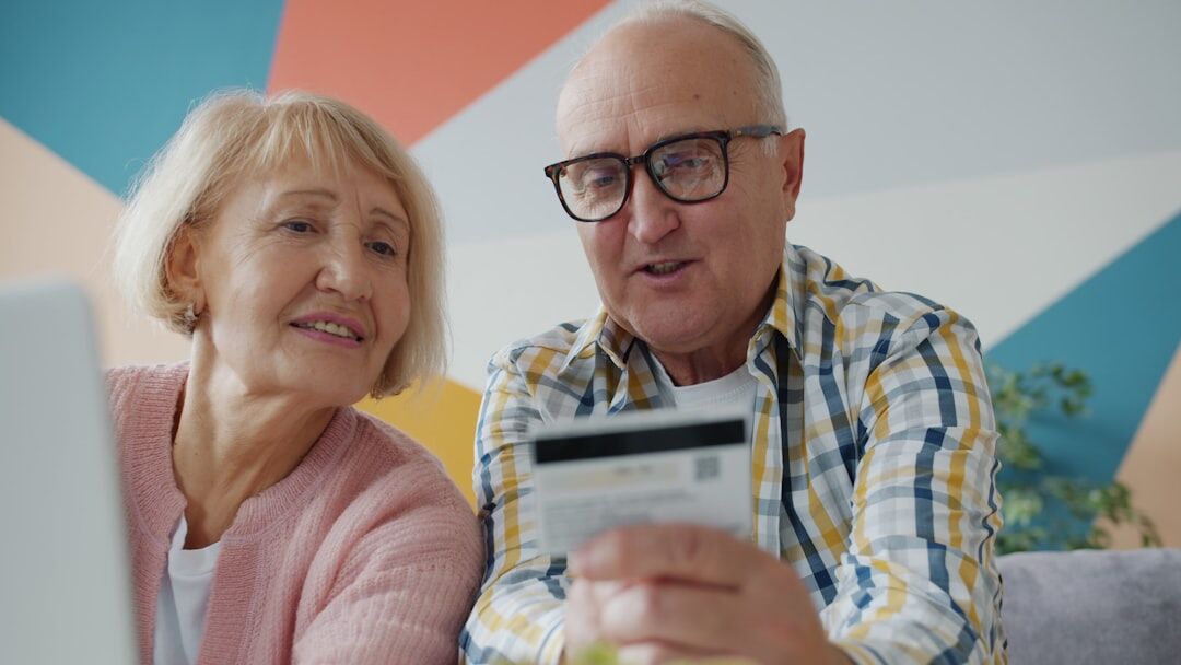 senior checking energy bill at home