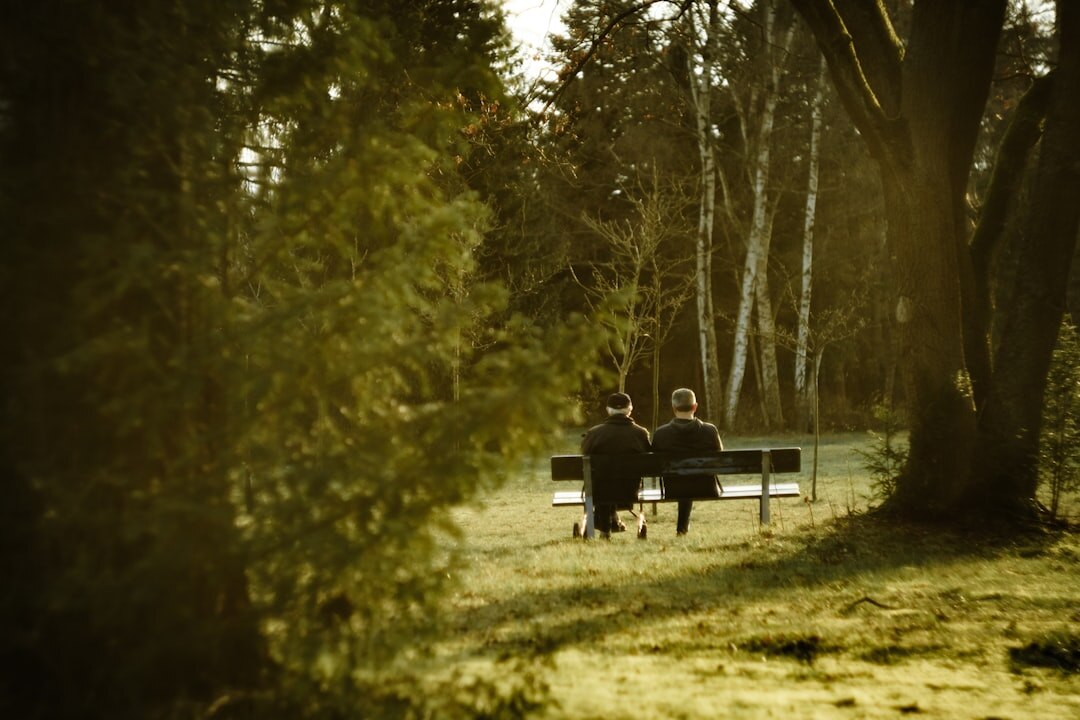 elderly couple walking in park