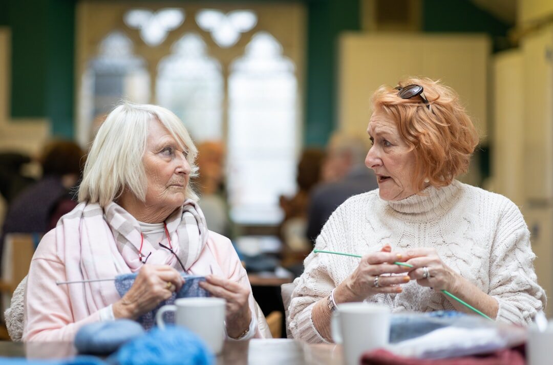 Seniors working together on a craft workshop at a table